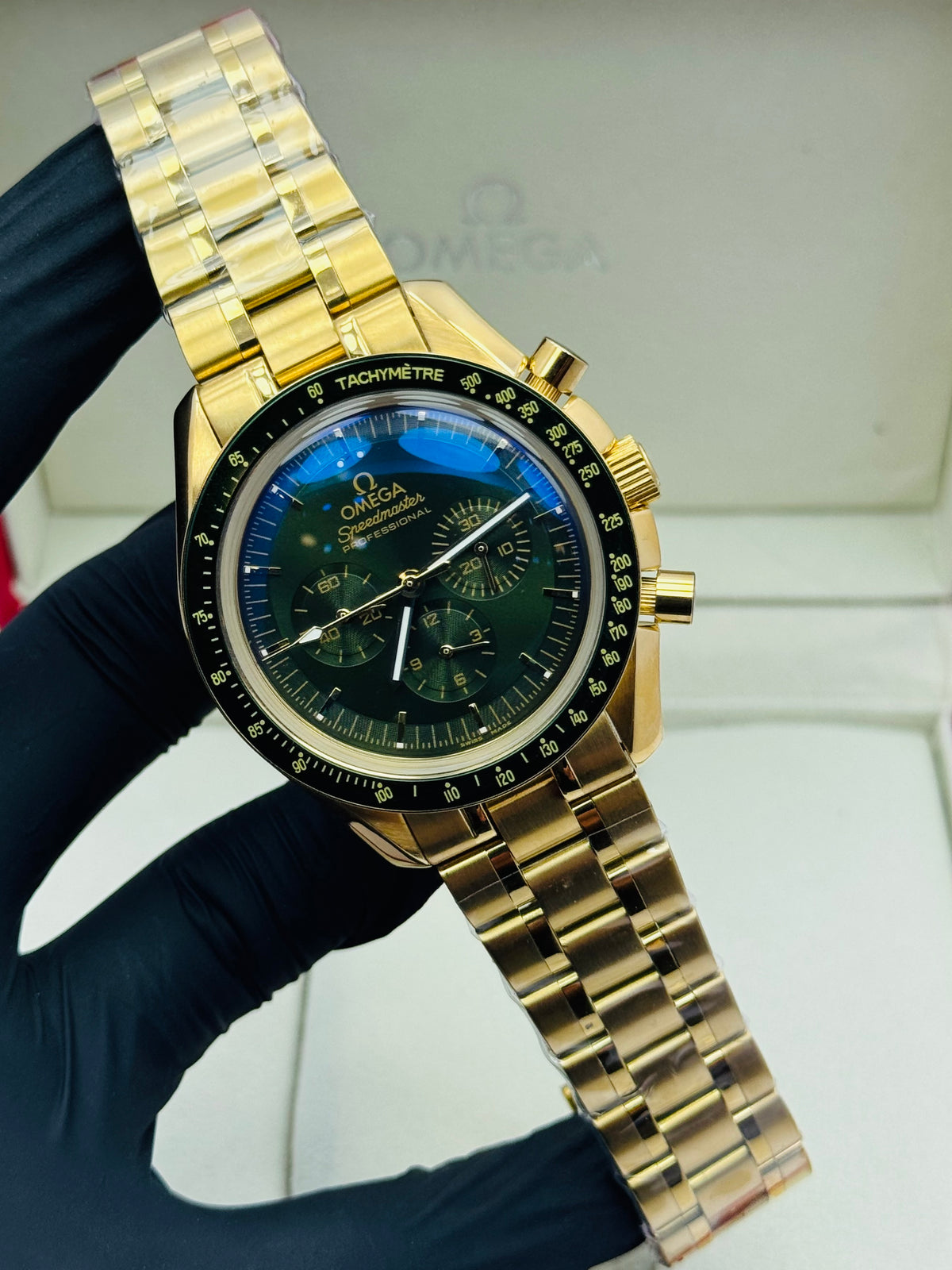 OMEGA SPEEDMASTER AUTOMATIC TRIPLE CHRONOGRAPHIC MODEL IN YELLOW GOLD GREEN CHAIN EDITION