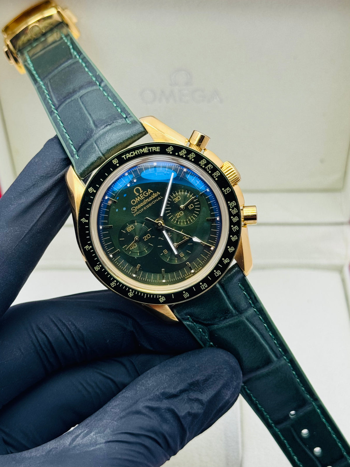 OMEGA SPEEDMASTER AUTOMATIC TRIPLE CHRONOGRAPHIC MODEL IN YELLOW GOLD & GREEN SPECIAL EDITION